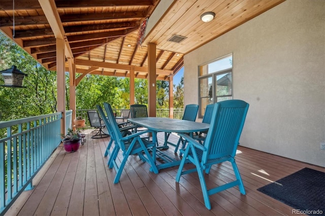 wooden deck with outdoor dining space and visible vents