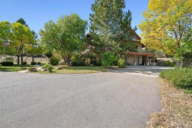 obstructed view of property with aphalt driveway