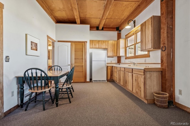 kitchen featuring freestanding refrigerator, baseboards, light colored carpet, light countertops, and wooden ceiling