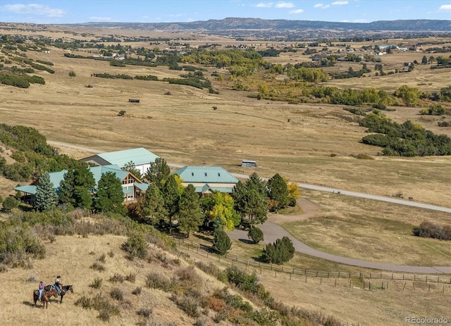 birds eye view of property with a mountain view and a rural view