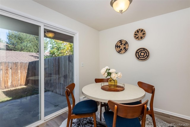 dining space with wood-type flooring