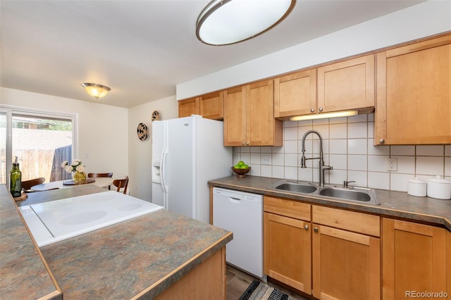 kitchen with white appliances, backsplash, and sink