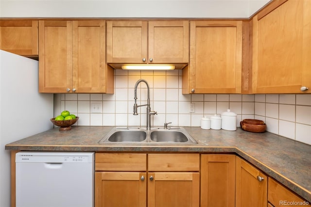 kitchen featuring decorative backsplash, sink, and white dishwasher