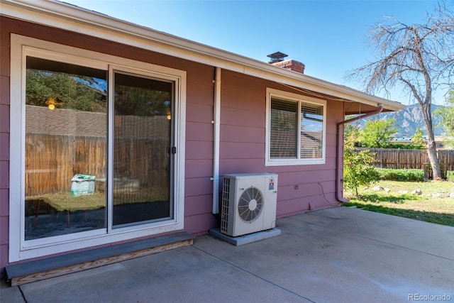 entrance to property with ac unit and a patio