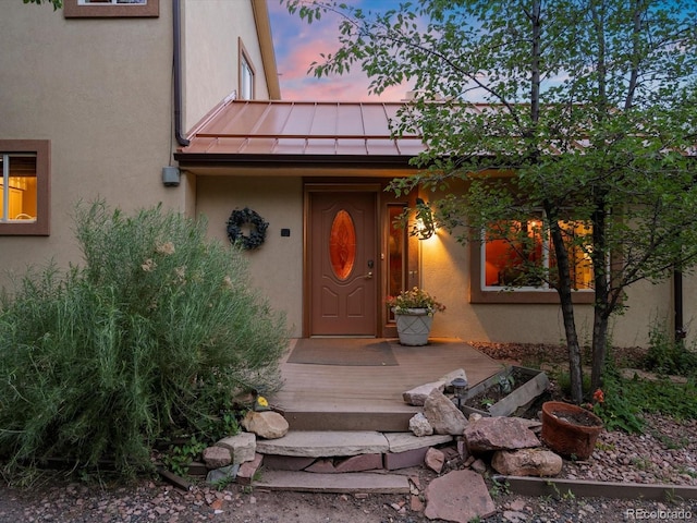 109 Bear Creek Ln, Morrison, CO 80465 - view of exterior entry with a standing seam roof, stucco siding, and a metal roof