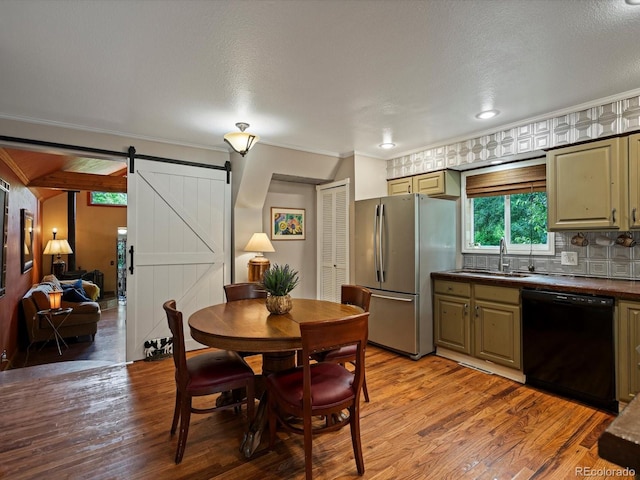 109 Bear Creek Ln, Morrison, CO 80465 - dining area with a barn door, light wood-type flooring, and crown molding
