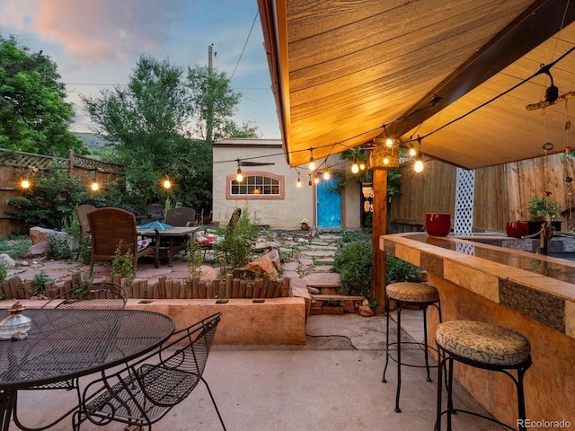 109 Bear Creek Ln, Morrison, CO 80465 - patio terrace at dusk featuring a patio and outdoor dining area