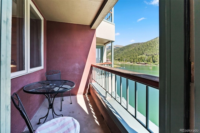 balcony with a water and mountain view