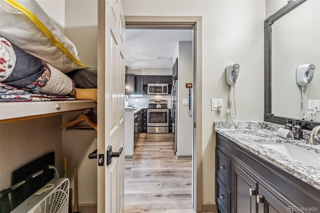 bathroom with vanity and hardwood / wood-style floors