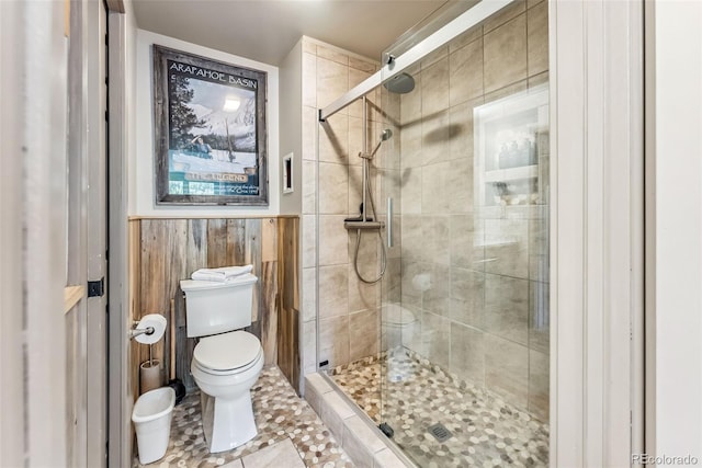 bathroom with walk in shower, toilet, and tile patterned floors