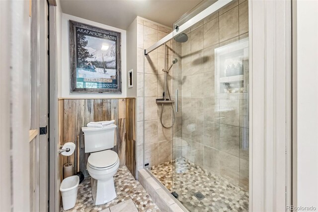 22174 US Highway 6 Unit 1535, Dillon, CO 80435 - full bathroom featuring toilet, a stall shower, wainscoting, and tile patterned flooring