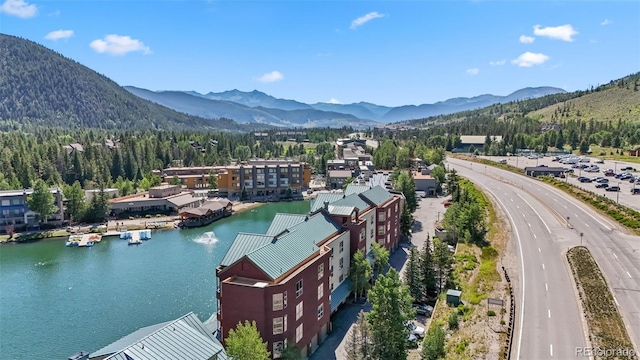 birds eye view of property featuring a water and mountain view