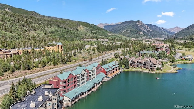 drone / aerial view with a water and mountain view