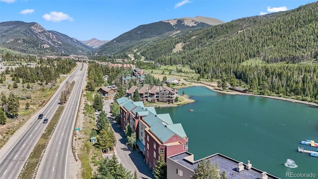 drone / aerial view featuring a water and mountain view