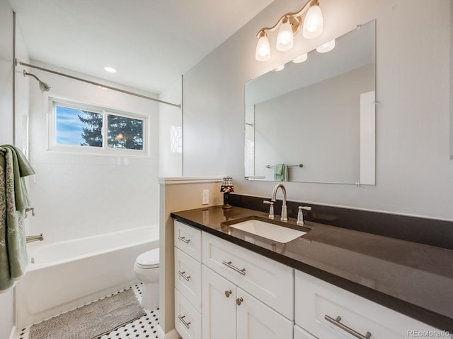 full bathroom featuring vanity, tiled shower / bath, and toilet