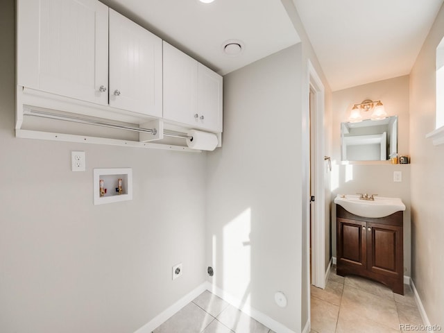 laundry room with sink, cabinets, light tile patterned floors, hookup for a washing machine, and hookup for an electric dryer