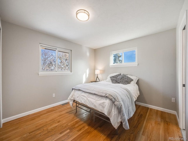 bedroom with hardwood / wood-style floors