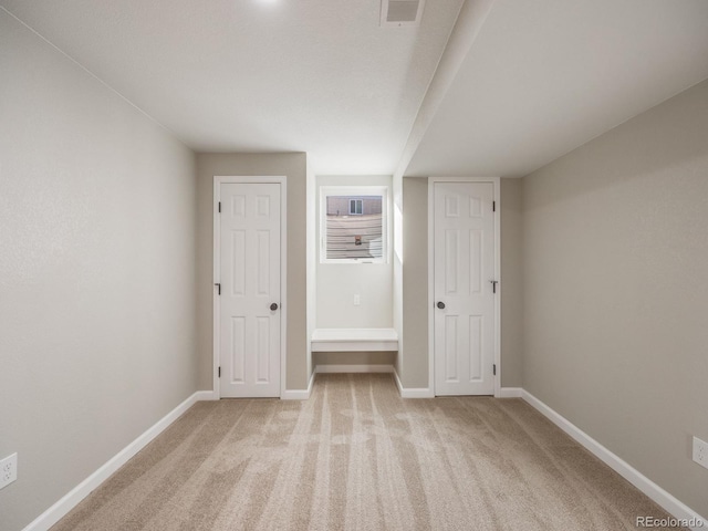 unfurnished bedroom featuring light colored carpet