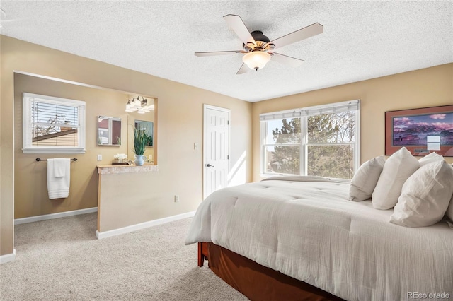 carpeted bedroom featuring a textured ceiling, ceiling fan, and baseboards