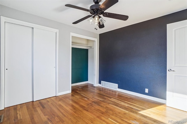 unfurnished bedroom featuring wood-type flooring and ceiling fan