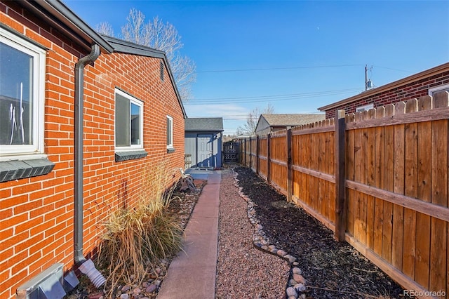 view of side of property with a storage unit