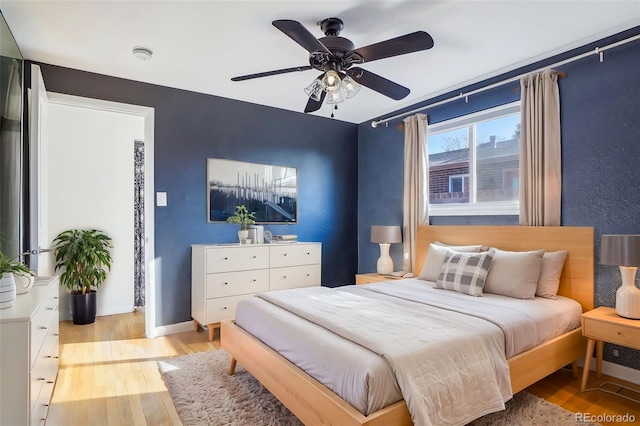 bedroom featuring light hardwood / wood-style flooring and ceiling fan