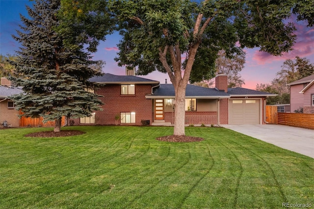 view of front facade with a lawn and a garage