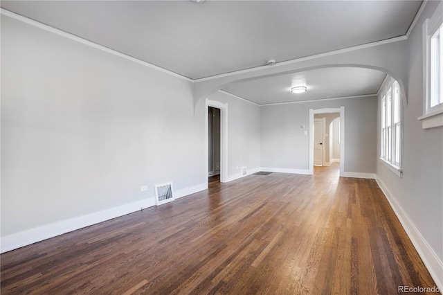 spare room with dark wood-type flooring and ornamental molding