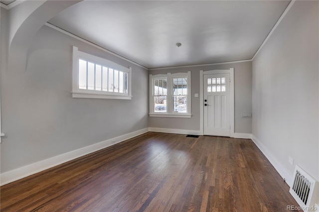 foyer featuring crown molding and dark hardwood / wood-style floors