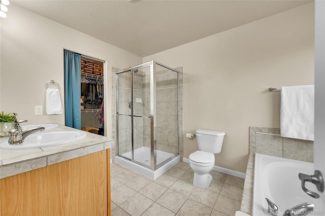 22801 E Briarwood Pl, Aurora, CO 80016 - bathroom with a shower stall, tile patterned flooring, a garden tub, a spacious closet, and a textured ceiling