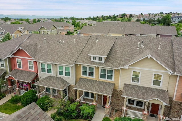 22801 E Briarwood Pl, Aurora, CO 80016 - multi unit property featuring a residential view, stone siding, covered porch, and a shingled roof