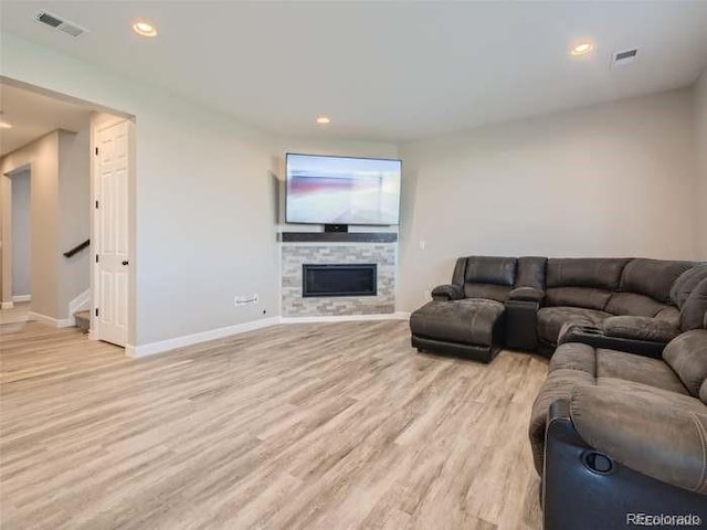 living room featuring light hardwood / wood-style floors and a fireplace