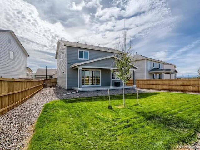 rear view of house with a lawn