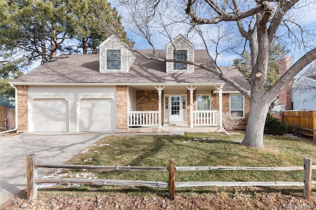 cape cod home featuring a front yard, a garage, and covered porch