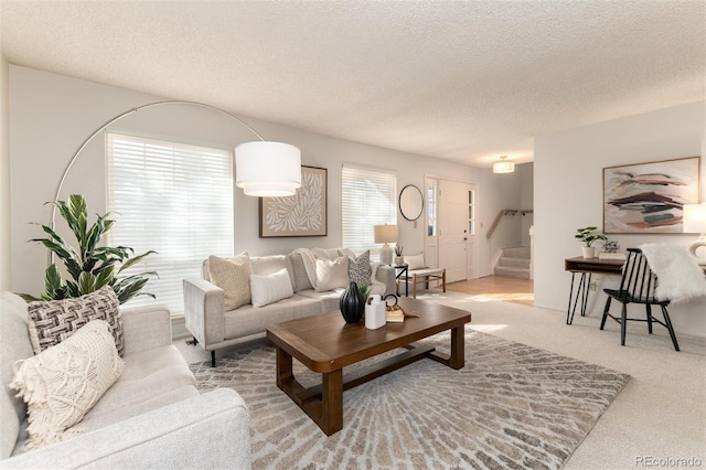 carpeted living room featuring a textured ceiling and a healthy amount of sunlight