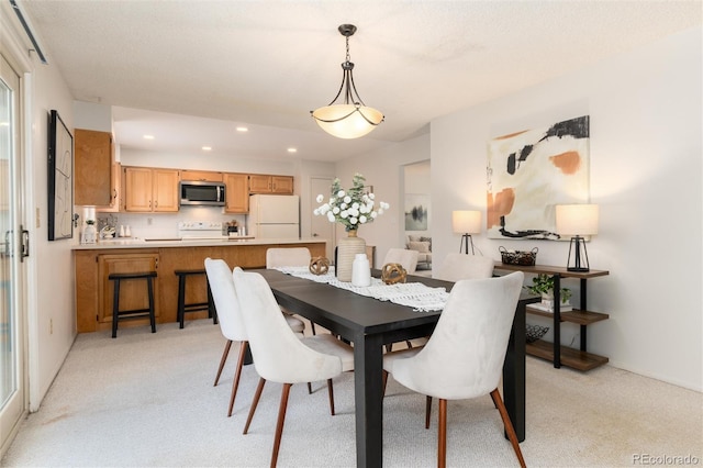 dining room with light colored carpet