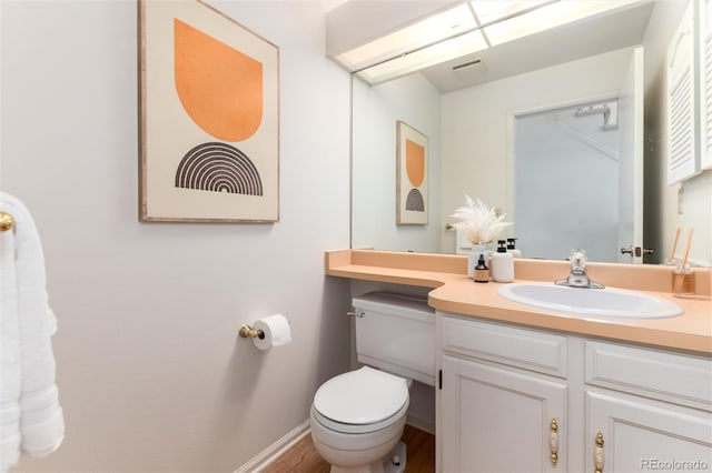 bathroom featuring toilet and vanity