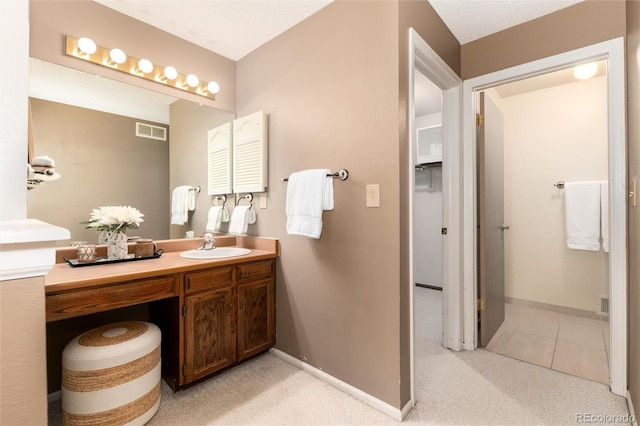 bathroom with a textured ceiling and vanity