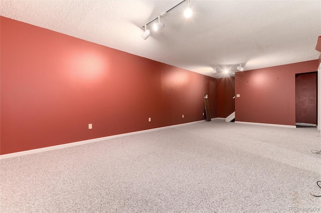 spare room with a textured ceiling and track lighting