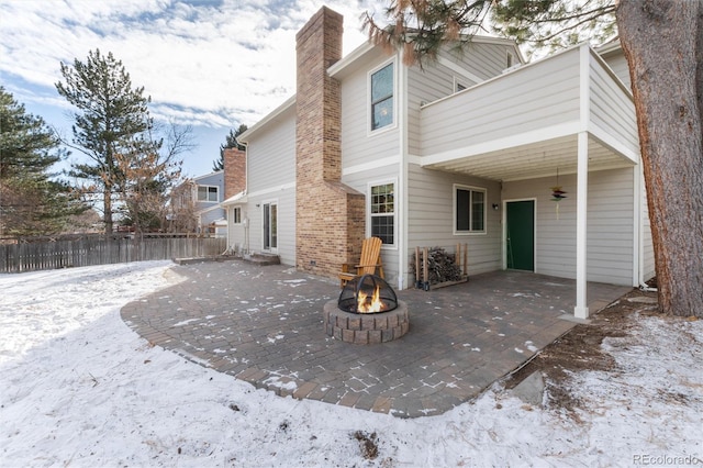 snow covered property with a patio, ceiling fan, and a fire pit