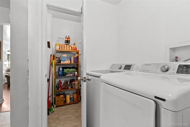 laundry area featuring light tile patterned floors, laundry area, and independent washer and dryer