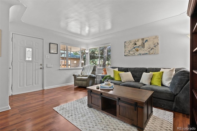 living room featuring baseboards and wood finished floors