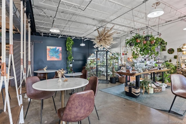 dining area featuring finished concrete floors