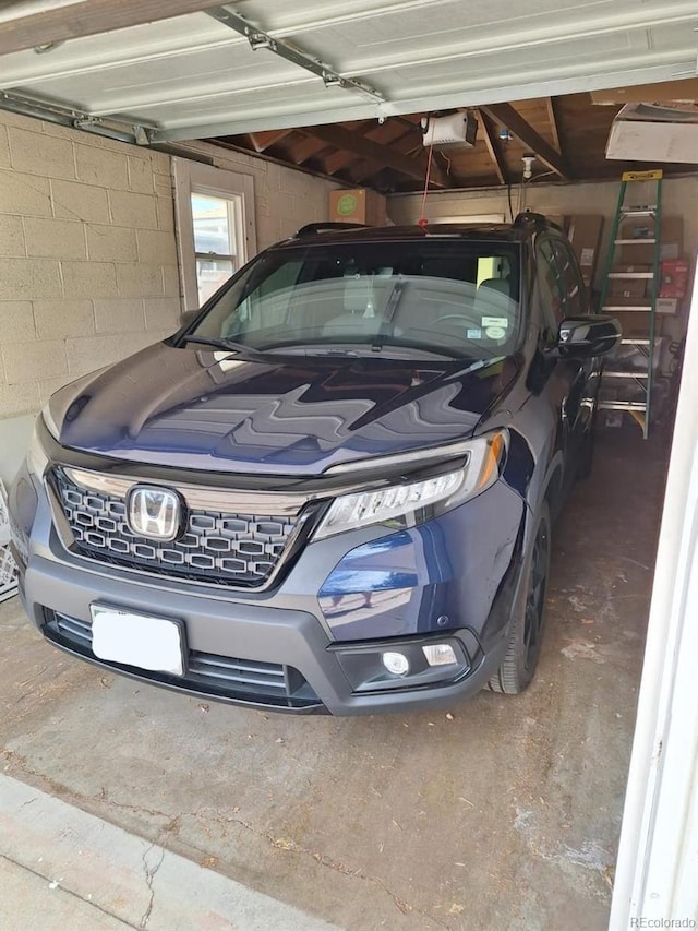 3667 Hudson St, Denver, CO 80207 - garage with a garage door opener and concrete block wall