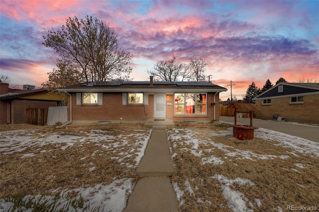 view of front of property with solar panels