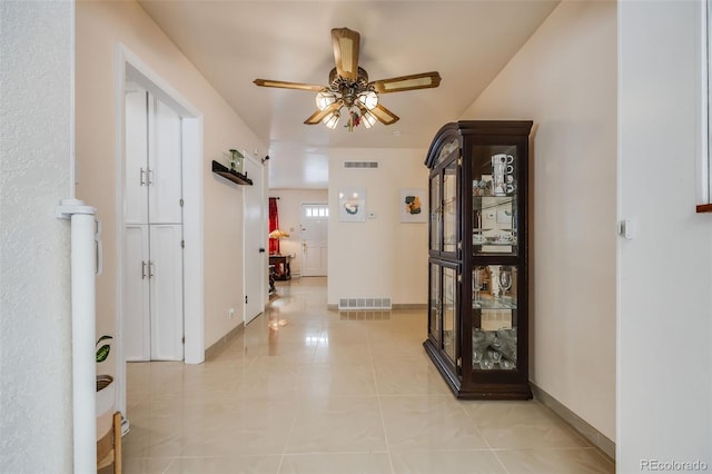 corridor featuring light tile patterned floors