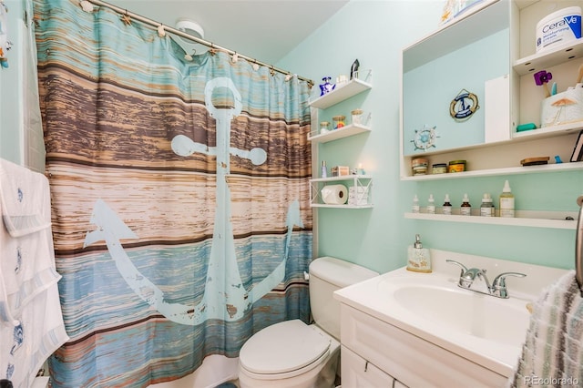 bathroom featuring a shower with shower curtain, vanity, and toilet