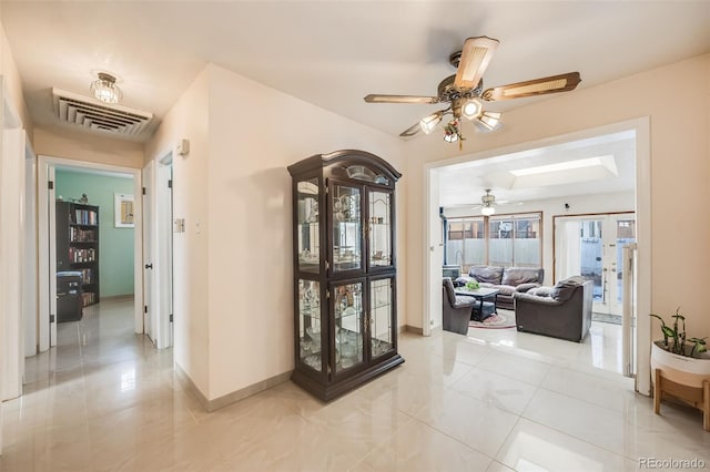 corridor featuring light tile patterned floors and french doors