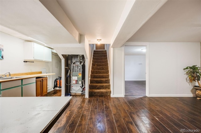 kitchen featuring sink, white cabinets, and dark wood-type flooring