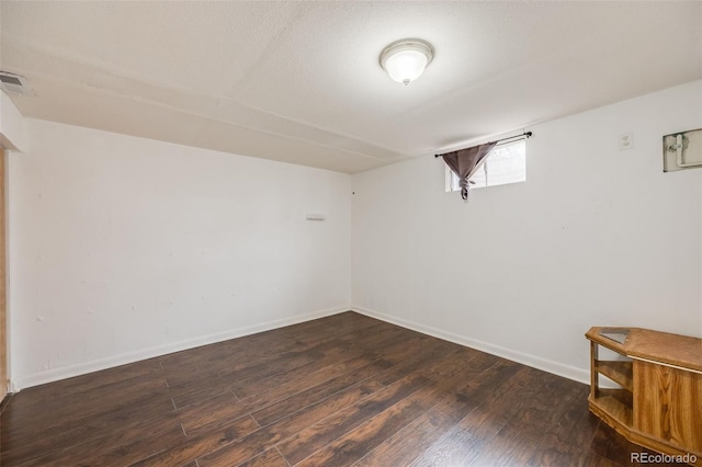 basement featuring dark hardwood / wood-style floors